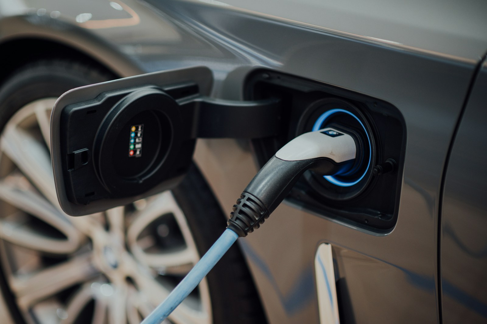 A charging cable plugged into a car inlet